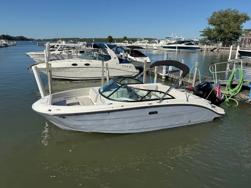 Slide: The Image of 2026 Sea Ray SDX 230 Outboard in a marina, surrounded by other boats. - 22
