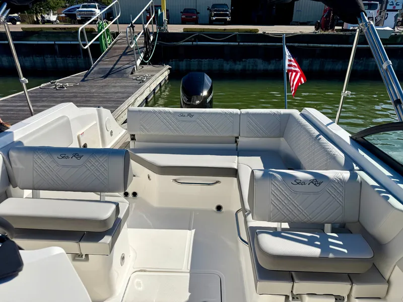 Slide: The Image of The image shows the cockpit of a 2026 Sea Ray SDX 230 Outboard with sleek white seating. - 7