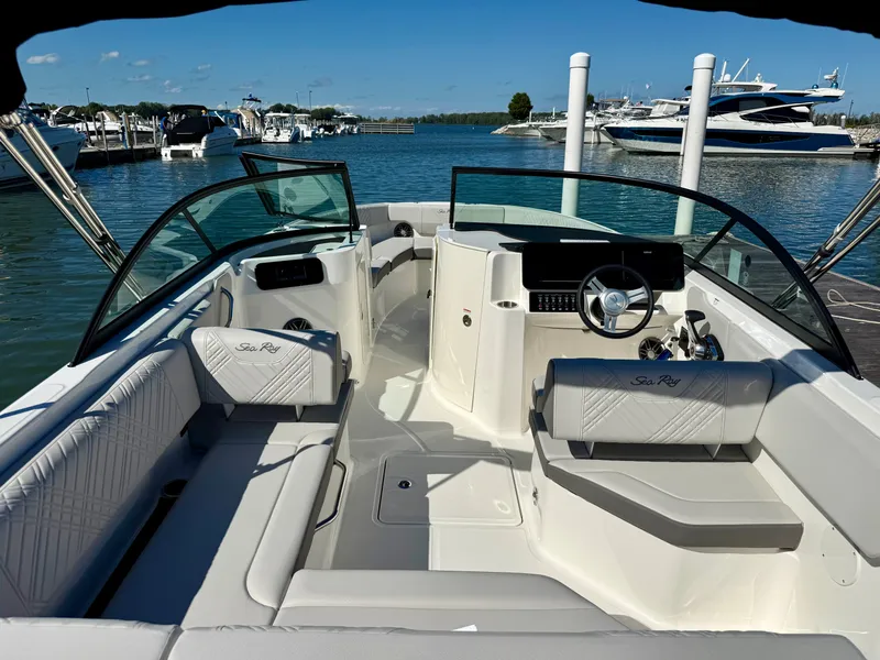 Slide: The Image of The image shows the cockpit of a 2026 Sea Ray SDX 230 Outboard with sleek seating and a modern helm. - 5