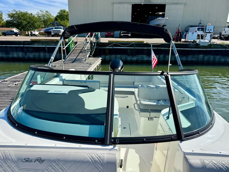 Slide: The Image of The image shows a 2026 Sea Ray SDX 230 Outboard boat docked. - 12