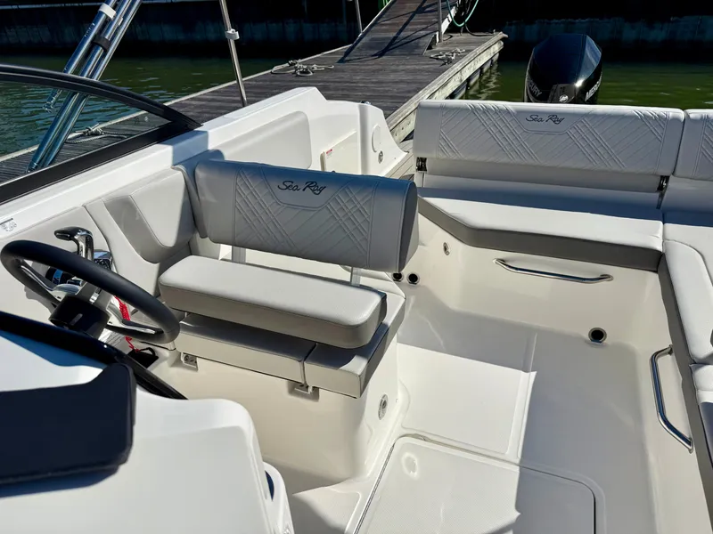 Slide: The Image of The image shows the cockpit of a Sea Ray SDX 230 Outboard boat with sleek seating. - 10
