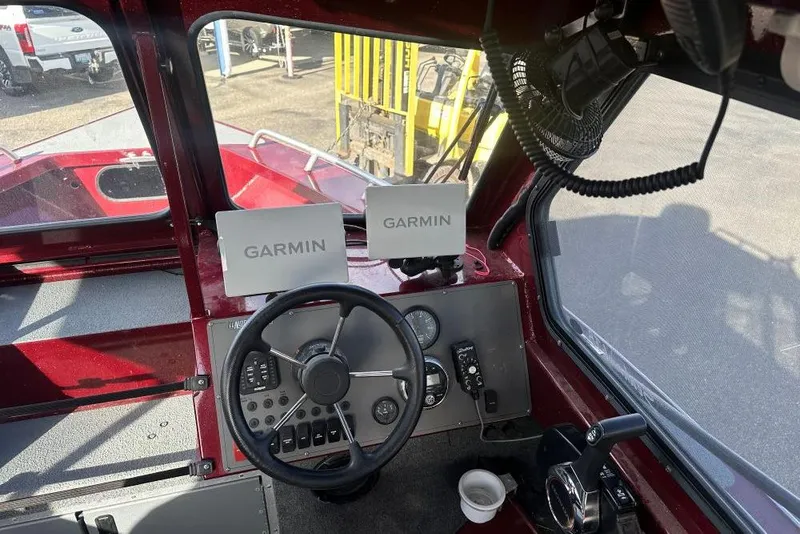 Slide: The Image of 2021 North River SEA HAWK boat cockpit with Garmin navigation displays and steering wheel. - 6