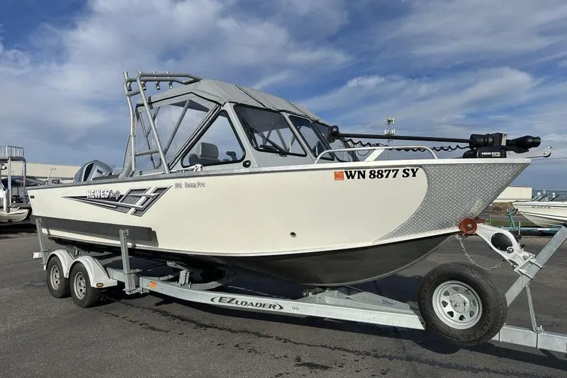 Slide: The Image of 2021 Hewescraft 240 Ocean Pro ET boat on trailer, parked outdoors. - 0