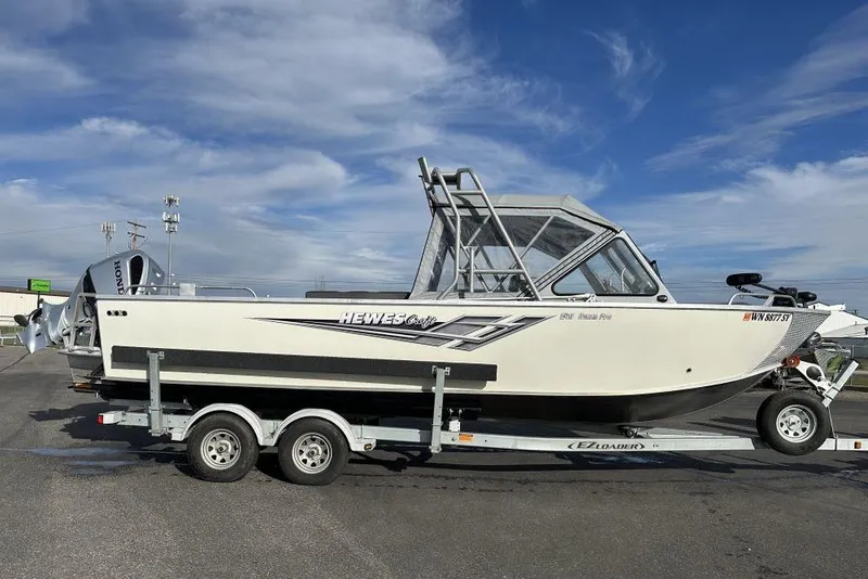 Slide: The Image of 2021 Hewescraft 240 Ocean Pro ET boat on trailer under blue sky. - 1