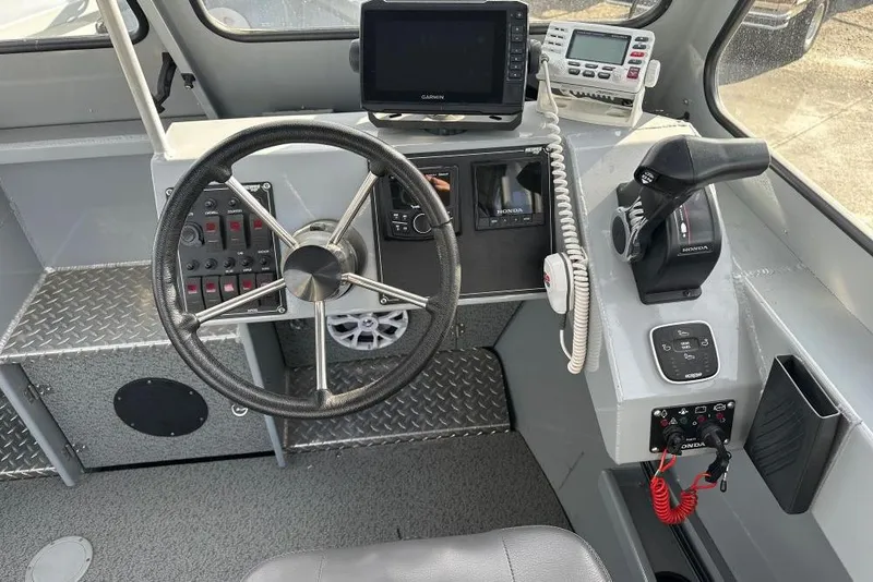 Slide: The Image of Helm of 2021 Hewescraft 240 Ocean Pro ET with steering wheel and navigation equipment. - 6