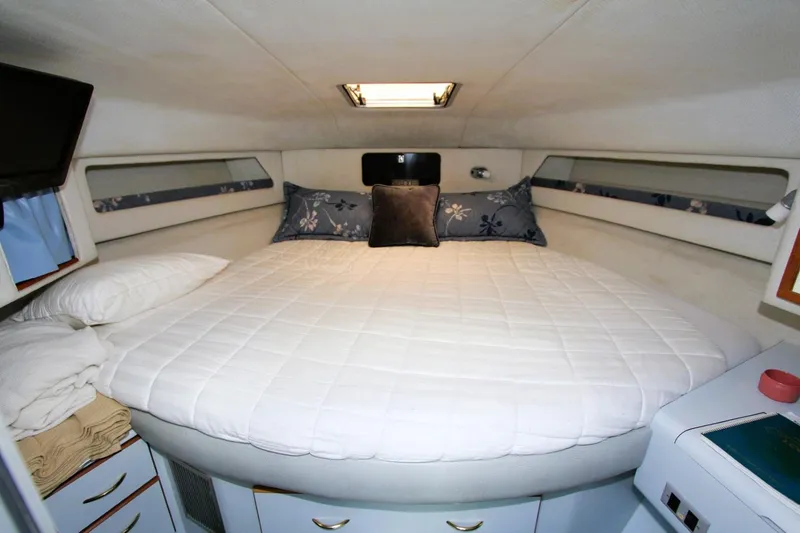 Slide: The Image of Cozy cabin interior of 1989 Sea Ray 345 Sedan Bridge with comfortable bedding. - 8