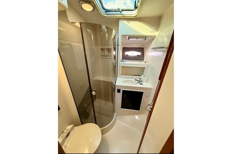 Slide: The Image of Bathroom interior of 1990 Tiara Yachts 3600 Open, featuring shower and sink. - 11