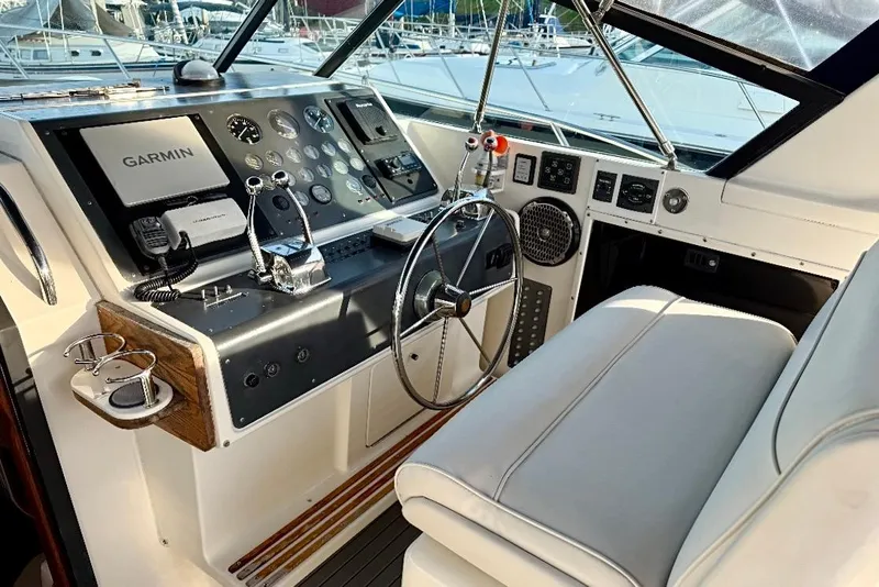 Slide: The Image of 1990 Tiara Yachts 3600 Open helm with Garmin navigation and classic controls. - 15