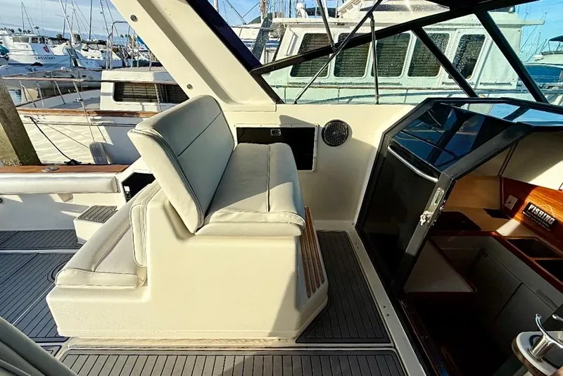 Slide: The Image of 1990 Tiara Yachts 3600 Open interior with helm seating and dashboard view. - 17