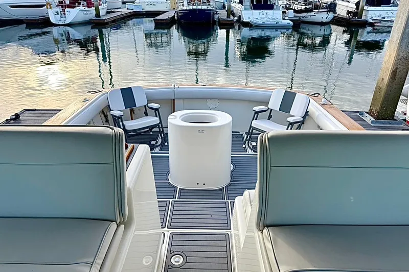 Slide: The Image of 1990 Tiara Yachts 3600 Open cockpit with seating, docked at marina. - 19
