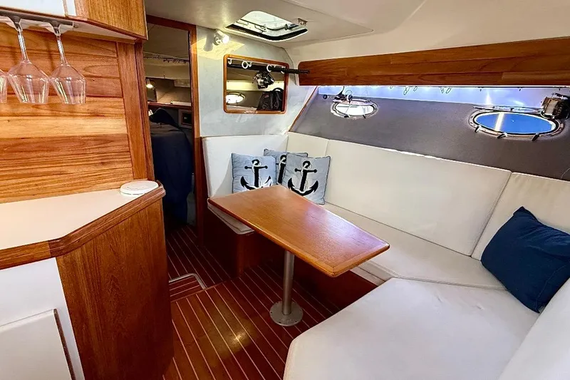 Slide: The Image of Cozy interior of 1990 Tiara Yachts 3600 Open with wooden accents and nautical decor. - 5