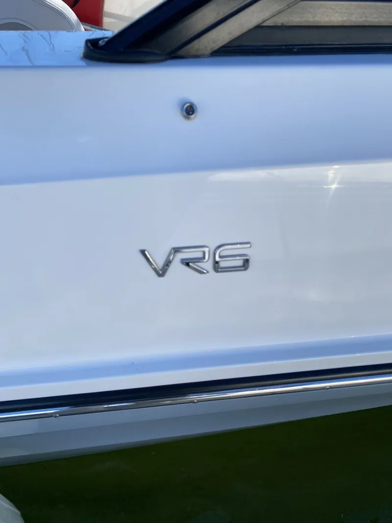 Slide: The Image of 2024 Bayliner VR6 boat, white exterior with VR6 emblem. - 7