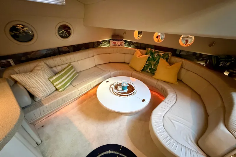 Slide: The Image of Luxurious interior of 1997 Sea Ray 500 Sundancer yacht with plush seating and round table. - 15