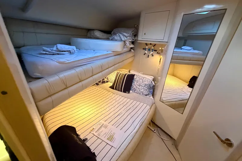 Slide: The Image of Interior cabin of 1997 Sea Ray 500 Sundancer yacht with cozy bedding and mirror. - 21