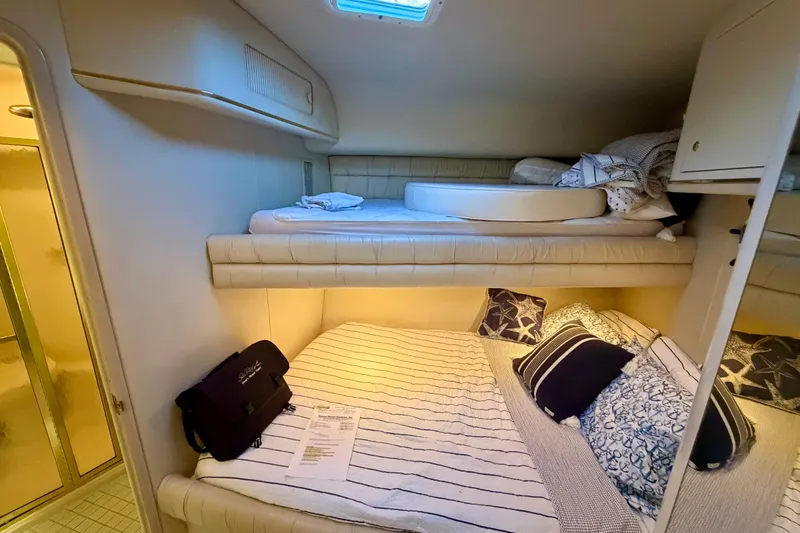 Slide: The Image of Interior cabin of 1997 Sea Ray 500 Sundancer with cozy bunk beds and nautical decor. - 22