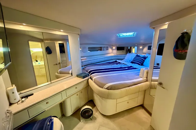 Slide: The Image of Luxurious 1997 Sea Ray 500 Sundancer cabin with cozy bed and elegant interior design. - 23