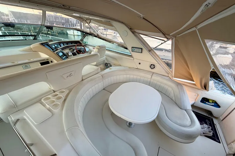 Slide: The Image of Luxurious 1997 Sea Ray 500 Sundancer yacht interior with plush seating and helm. - 39