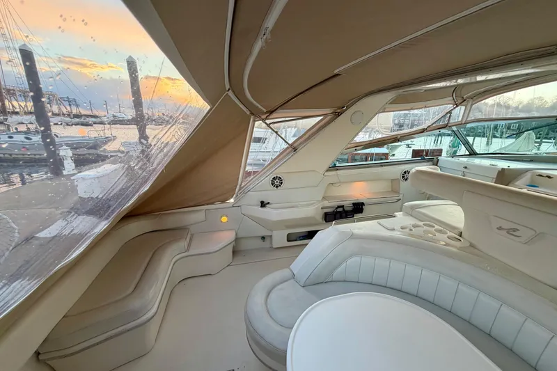 Slide: The Image of Interior of 1997 Sea Ray 500 Sundancer yacht at sunset, featuring elegant seating and marina view. - 6
