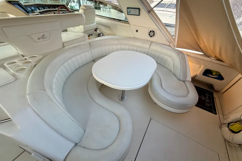 Slide: The Image of Luxurious 1997 Sea Ray 500 Sundancer yacht interior with white leather seating and table. - 7