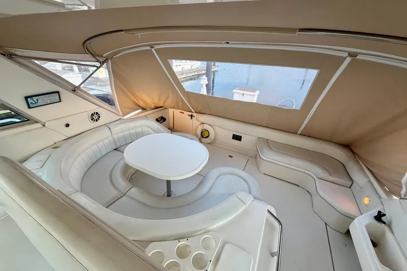 Slide: The Image of 1997 Sea Ray 500 Sundancer yacht interior with white seating and round table. - 8