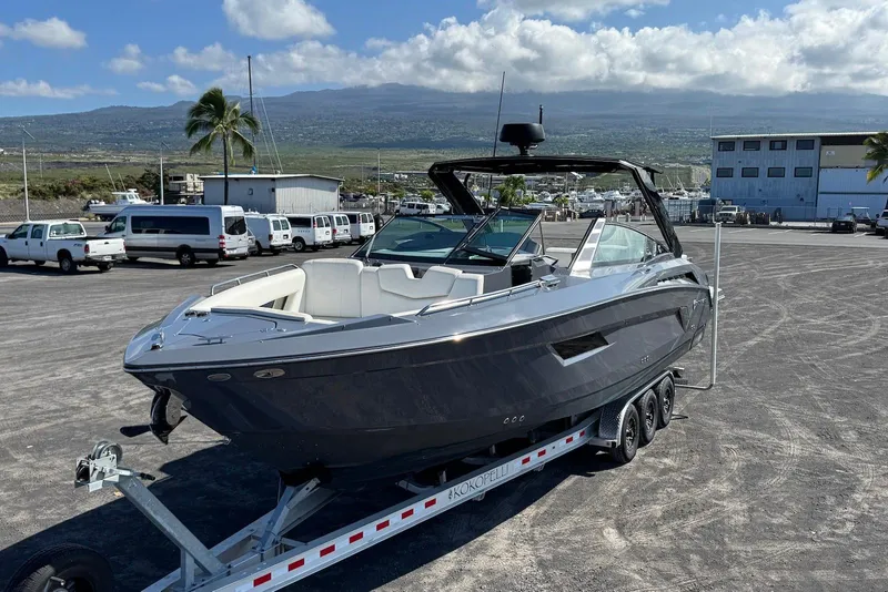 Slide: The Image of 2022 Cruisers Yachts 338 South Beach Edition Bow Rider on trailer, parked in marina lot. - 10