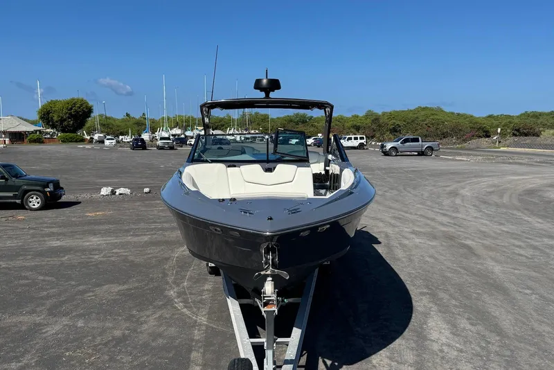 Slide: The Image of 2022 Cruisers Yachts 338 South Beach Edition Bow Rider on trailer in parking lot. - 11