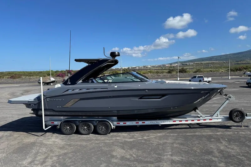 Slide: The Image of 2022 Cruisers Yachts 338 South Beach Edition Bow Rider on trailer, parked outdoors. - 13