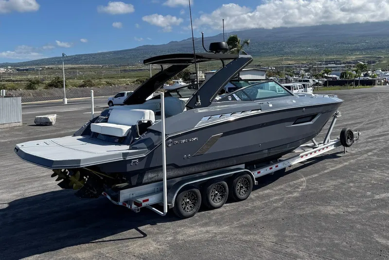 Slide: The Image of 2022 Cruisers Yachts 338 South Beach Edition Bow Rider on trailer, scenic background. - 14