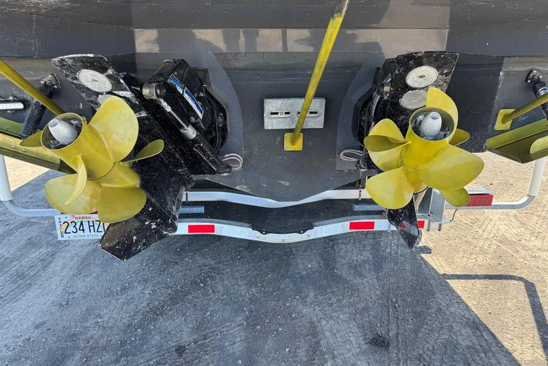 Slide: The Image of 2022 Cruisers Yachts 338 South Beach Edition Bow Rider with dual propellers on trailer. - 17