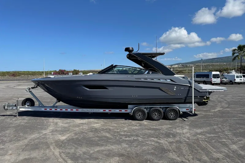 Slide: The Image of 2022 Cruisers Yachts 338 South Beach Edition Bow Rider on trailer, parked outdoors. - 9