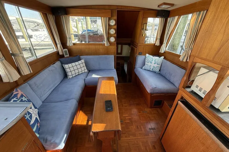 Slide: The Image of Interior of 1985 Grand Banks 36 Classic yacht with cozy seating and wooden decor. - 10