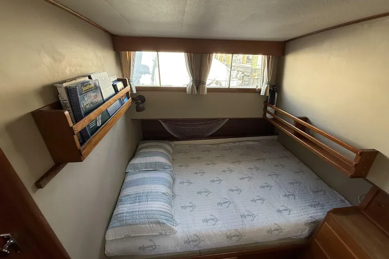 Slide: The Image of Cozy cabin interior of 1985 Grand Banks 36 Classic with bed and bookshelf. - 15