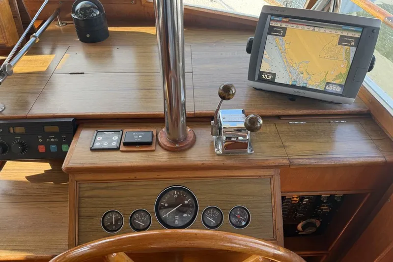 Slide: The Image of 1985 Grand Banks 36 Classic helm with navigation equipment and wooden dashboard. - 17