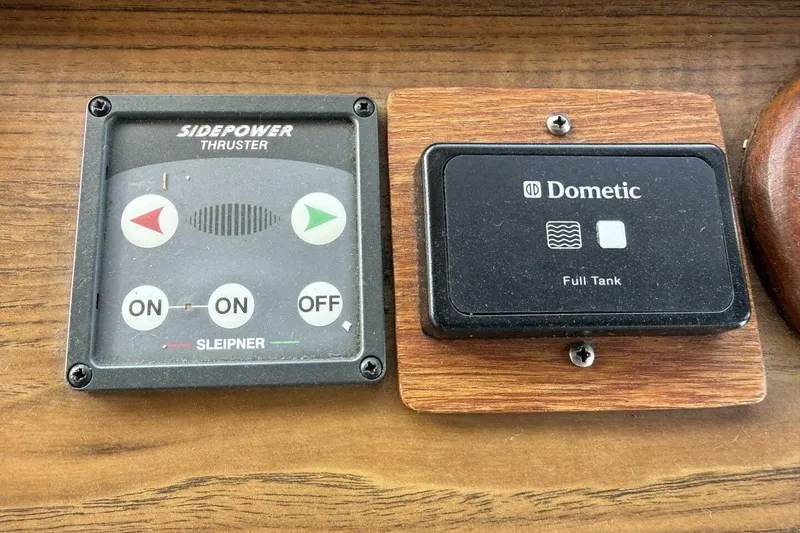 Slide: The Image of Control panels on a 1985 Grand Banks 36 Classic boat, featuring Sidepower thruster and Dometic tank monitor. - 19
