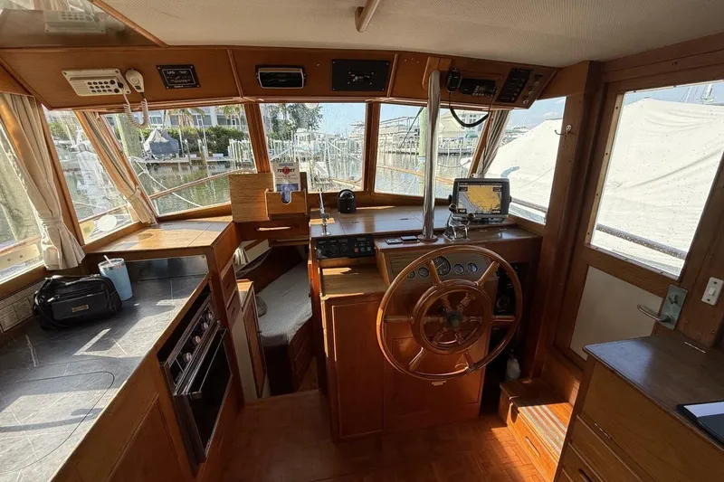 Slide: The Image of 1985 Grand Banks 36 Classic boat interior with wooden helm and navigation equipment. - 7