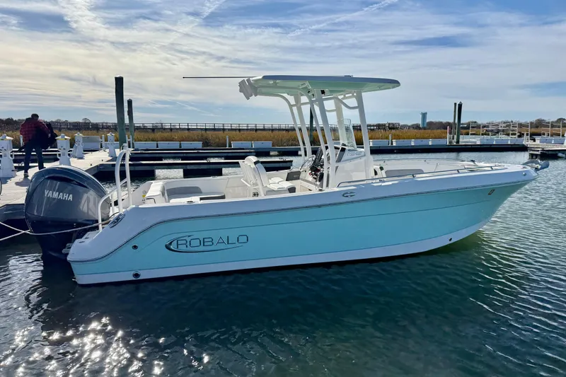 The Image of 2022 Robalo R242 Explorer boat docked with Yamaha engine, under clear sky. - 0