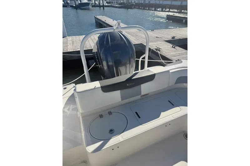 Slide: The Image of 2022 Robalo R242 Explorer boat at dock, featuring sleek design and powerful engine. - 20