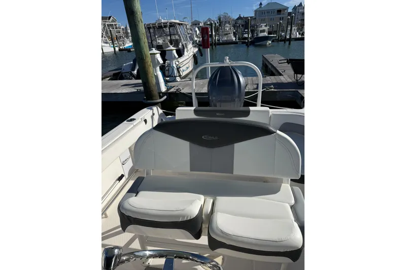Slide: The Image of 2022 Robalo R242 Explorer boat interior with seating at marina. - 22