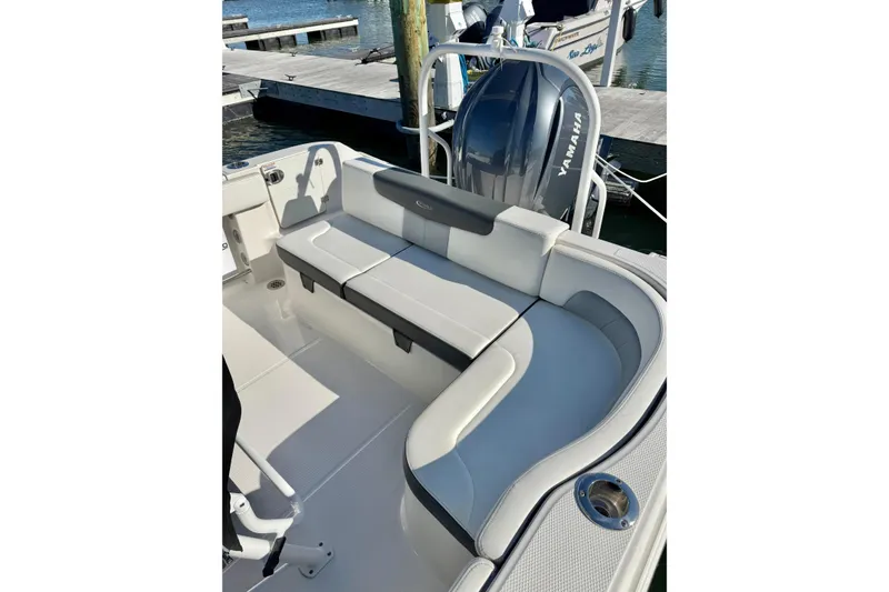 Slide: The Image of 2022 Robalo R242 Explorer boat interior with cushioned seating and Yamaha engine. - 4