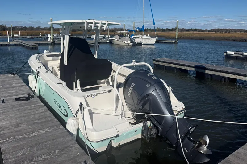 Slide: The Image of 2022 Robalo R242 Explorer boat docked with Yamaha outboard motor. - 9