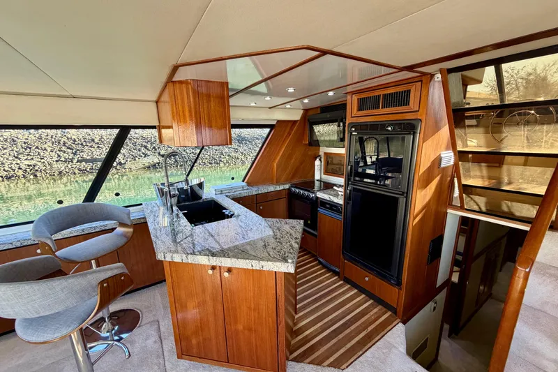 Slide: The Image of Luxurious 1995 Bayliner 4788 Pilot House Motoryacht interior with modern kitchen and seating. - 11