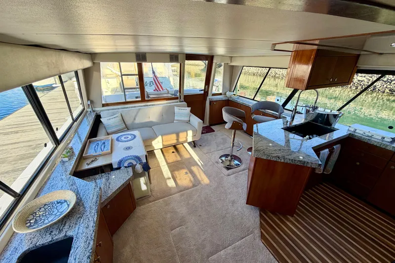 Slide: The Image of Luxurious interior of 1995 Bayliner 4788 Pilot House Motoryacht with modern kitchen and seating area. - 13