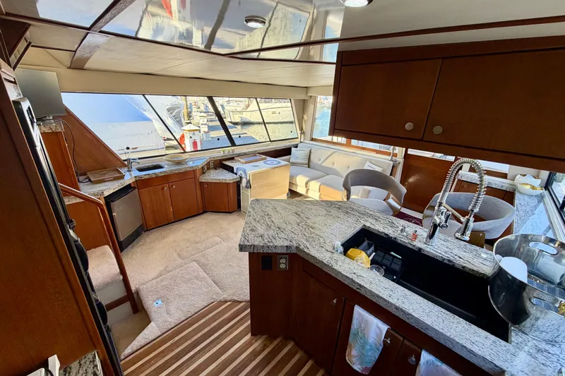 Slide: The Image of Luxurious interior of 1995 Bayliner 4788 Pilot House Motoryacht with modern kitchen and seating area. - 16