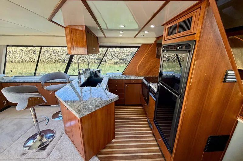 Slide: The Image of Luxurious 1995 Bayliner 4788 Pilot House Motoryacht interior with modern kitchen and seating. - 18