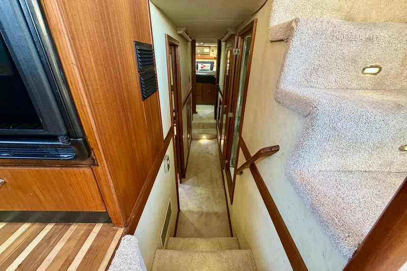 Slide: The Image of Interior hallway of 1995 Bayliner 4788 Pilot House Motoryacht with carpeted stairs. - 19