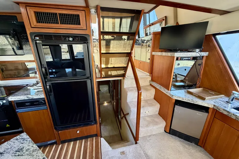 Slide: The Image of Interior of 1995 Bayliner 4788 Pilot House Motoryacht with kitchen and stairs. - 20