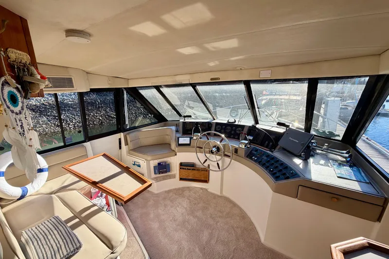 Slide: The Image of Interior of 1995 Bayliner 4788 Pilot House Motoryacht with steering wheel and navigation equipment. - 21