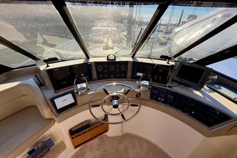 Slide: The Image of 1995 Bayliner 4788 Pilot House Motoryacht helm with steering wheel and navigation equipment. - 22