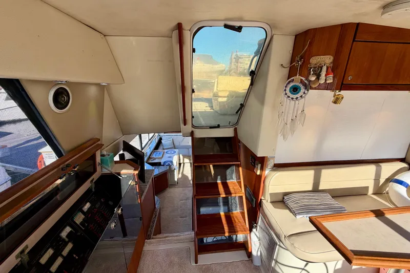 Slide: The Image of Interior of 1995 Bayliner 4788 Pilot House Motoryacht with wooden stairs and seating area. - 25