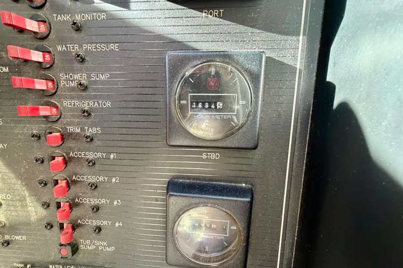 Slide: The Image of Control panel of a 1995 Bayliner 4788 Pilot House Motoryacht with hour meters and switches. - 28